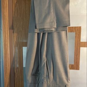 A pin striped gray and white suit